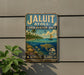A vintage metal sign for the Jaluit Conservation Area in Marshall Islands, featuring a tropical beach scene with palm trees, a sailboat, and a turtle.