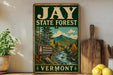 A vintage-style metal sign for the Jay State Forest in Vermont, featuring a scenic illustration of a forest and mountains.