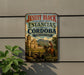 A vintage-style metal sign with the text "JESUIT BLOCK AND ESTANCIAS OF CORDOBA ARGENTINA" and an illustration of a man riding a horse in front of a historical building.