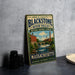 A vintage metal sign for John H. Chaffe's Blackstone River Valley National Heritage Corridor, featuring an illustration of a river and buildings, is displayed on a gray countertop.