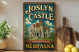 A vintage-style sign for "Joslyn Castle" in Nebraska, featuring an illustration of a castle surrounded by trees and a blue sky.