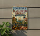 A vintage metal sign on a wall, depicting a ship sailing on a river, with a banner that reads "Journey Through Hallowed Ground - National Heritage Area - Maryland".