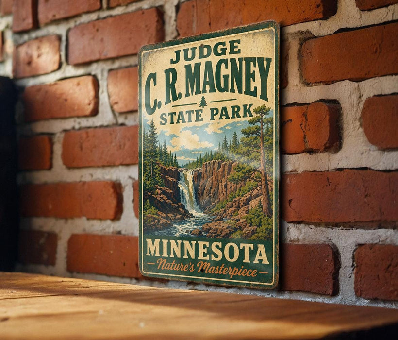 A vintage-style metal sign for C.R. Magney State Park in Minnesota, featuring a scenic landscape with a waterfall and pine trees.