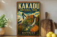 A vintage-style poster advertising Kakadu National Park in Australia, featuring a blue and white bird, a waterfall, and lush greenery.