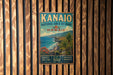 A vintage-style metal sign for the Kanalo Natural Area Reserve in Hawaii, featuring a tropical landscape with palm trees, mountains, and the ocean.