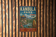 A vintage metal sign for Kanbula Park in China, featuring a scenic landscape with mountains, a temple, and a river.