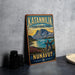 A vintage-style metal sign for Katanvilik Territorial Park, featuring a scenic landscape with mountains, a lake, and a rock formation.