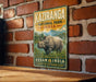 a vintage-style sign for Kaziranga National Park, India, depicting a rhinoceros in a grassy field.