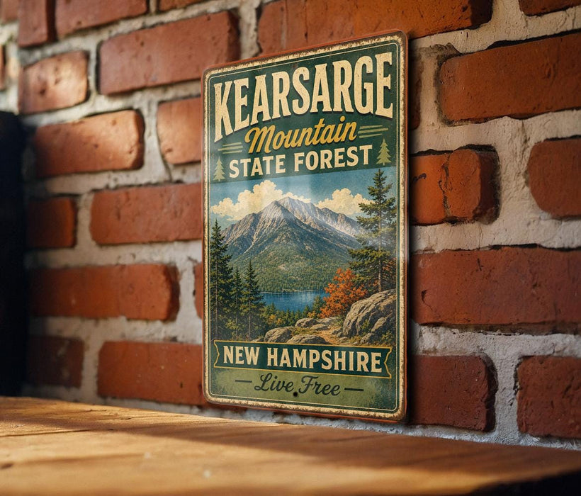 A vintage metal sign for the state forest in New Hampshire, featuring a mountain landscape and the text "Kearsarge Mountain State Forest New Hampshire Live Free".