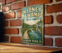 A vintage-style metal sign for Keeney Swamp State Forest in New York, featuring a scenic illustration of a path leading through the forest and a large bird, such as a crane, in the background.