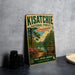 A vintage-style metal sign for the Kisatchie National Forest in Louisiana, featuring a scenic landscape with pine trees, a lake, and a sign indicating the area as a wildlife habitat and scenic trail.