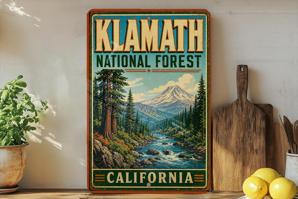 A vintage-style poster of Klamath National Forest in California, featuring a scenic mountain landscape with a river and pine trees.