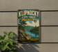 A vintage-style metal sign for Klipnocky State Forest in New York, featuring a scenic landscape with pine trees, a lake, and mountains.