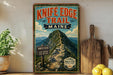 A vintage-style metal sign for Knife Edge Trail in Maine, featuring a mountain landscape and trail markings.