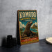 A vintage-style metal sign for Komodo National Park, Indonesia, featuring an illustration of a Komodo dragon and the text "LAND OF DRagons" and "ADVENTURE - NATURAL BEAUTY".
