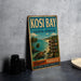 A vintage-style metal sign for Kosi Bay, South Africa, featuring a tropical beach scene with palm trees and a turtle.