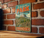 A vintage-style metal sign with the text "Kula-Salihli PARK" and "TÜRKIVEE" hangs on a brick wall.