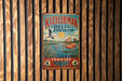 A vintage-style metal sign with a bird illustration and text, hanging on a wooden wall.