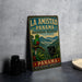 A vintage-style metal sign for the La Amistad Panama Biosphere Reserve, featuring a colorful illustration of a bird and a black panther in a lush, tropical landscape.