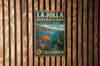 A vintage metal sign for La Jolla Underwater Park, an ecological reserve in California, featuring an illustration of underwater life and a seal.