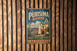 A vintage metal sign with the text "La Purismo Mission State Historic Park California" is displayed on a wooden wall.