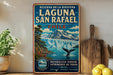 A vintage-style metal sign advertising the Laguna San Rafael, a natural reserve in Chile, featuring a scenic landscape with a waterfall and a whale.