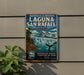 A vintage-style metal sign for the Laguna San Rafael in Chile, featuring a mountain landscape and a whale.