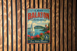 A vintage-style metal sign for Lake Balaton, Hungary, featuring a sailboat and a scenic landscape.