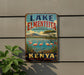 A vintage-style sign for Lake Elmenteita, the Bird Watchers Paradise of Kenya, featuring a scenic landscape with flamingos and palm trees.