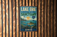 A vintage-style metal sign for Lake Erie National Marine Sanctuary, featuring a lighthouse, fish, and a scenic ocean view.