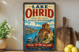 A vintage-style sign for Lake Ohrid, North Macedonia, featuring a scenic illustration of the lake and surrounding landscape.