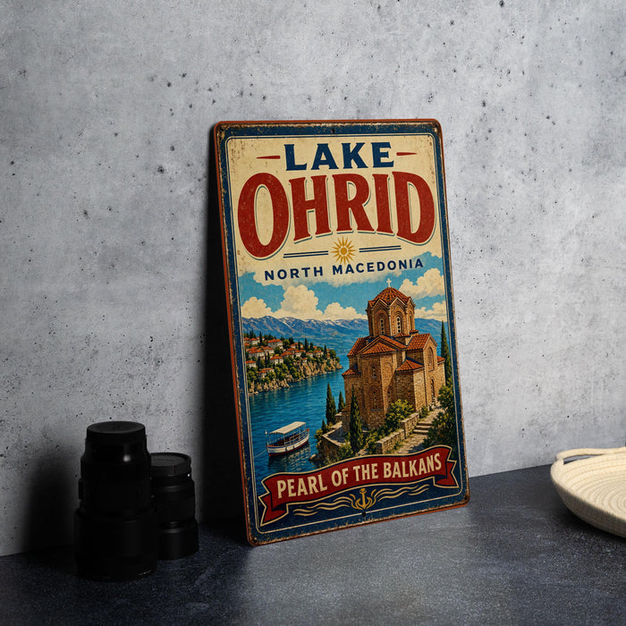 A vintage-style sign for Lake Ohrid, located in North Macedonia, featuring a scenic illustration of the town and its surroundings.
