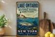 A vintage-style sign for Lake Ontario National Marine Sanctuary in New York, featuring a lighthouse, a sailboat, and a fish in the water.