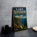 A vintage-style sign for Lake Superior State Forest, featuring a scenic landscape with pine trees, a lake, and mountains.