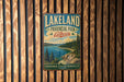 A vintage-style metal sign for Lakeland Provincial Park in Alberta, Canada, featuring a scenic landscape with a lake, mountains, and pine trees.