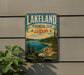 A vintage-style metal sign for Lakeland Provincial Park, Alberta, featuring a scenic landscape with pine trees, a lake, and mountains.