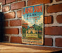 A vintage metal sign for Lang Son Park in Vietnam, featuring an illustration of the park's architecture and landscape.