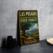 A vintage-style sign for Las Posadas, the demonstration state forest in California, featuring a scenic landscape with a large tree and mountains in the background.