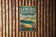A vintage-style metal sign with the text "LENCÔIS MARANHENES" and "NATIONAL PARK" is displayed on a wooden wall.