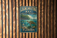 A vintage metal sign for Lignum Vitae Key Aquatic Preserve in Florida, featuring an illustration of a turtle swimming in the ocean.