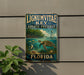 A vintage-style metal sign for the Lignum Vitae Key Aquatic Preserve in Florida, featuring a turtle, fish, and palm trees in a tropical setting.