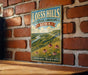 A vintage-style metal sign for Loess Hills, Iowa, featuring a scenic landscape with a river, mountains, and flowers.