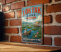 A vintage-style sign for "Loktak Lake" in Manipur, India, featuring a boat on the lake and a person in traditional clothing.