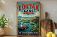 A vintage-style poster of the floating lake in Manipur, India, featuring a person in a boat on the water surrounded by floating lily pads and a wooden hut.