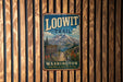 A vintage metal sign for the Loowit Trail in Washington, featuring a mountain landscape and a trail sign.