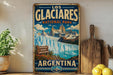 A vintage-style sign for the Los Glaciers National Park in Argentina, featuring a scenic image of the park's natural beauty.