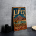 A vintage metal sign for "Los Lípez Bolivia" featuring a llama and a mountain landscape.