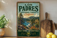 A vintage-style metal sign for the Los Padres National Forest in California, featuring a scenic landscape with mountains, trees, and a river.