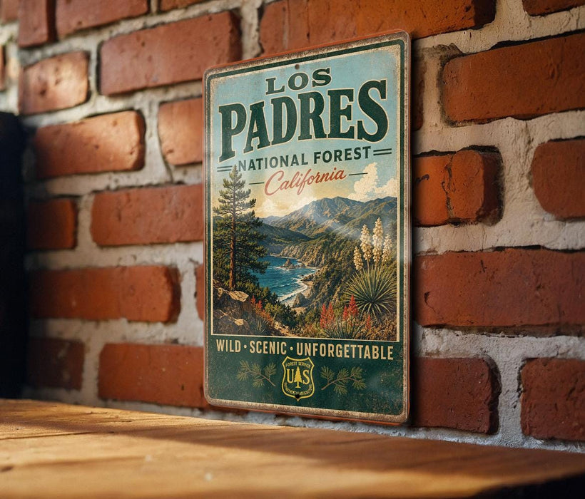 A vintage-style metal sign for the Los Padres National Forest in California, featuring a scenic landscape with mountains, trees, and a river.