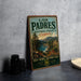 A vintage-style sign for the Los Padres National Forest in California, featuring a scenic landscape with mountains, trees, and a body of water.